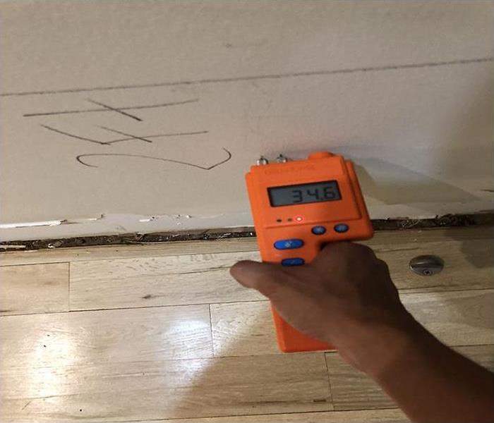 checking the moisture content of a wall