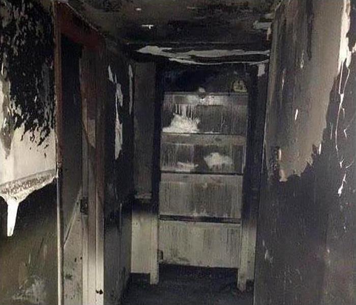 fire damaged hallway covered in soot