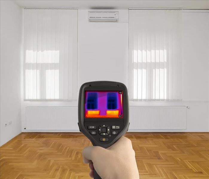 thermal imaging camera pointing at two windows and a wall