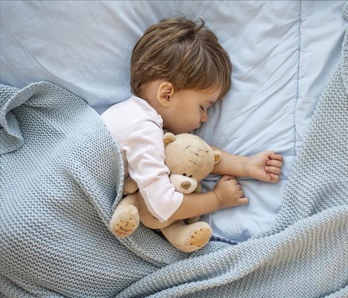 toddler sleeping with teddy bear